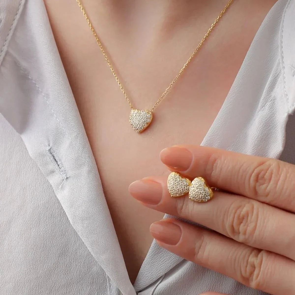 Minimal taşlı kalp kolye-küpe set, takıların model üzerinde birlikte kullanımı.